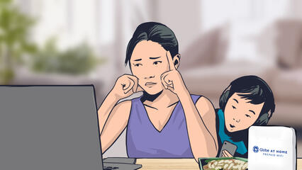 A worried woman looks at her laptop while a child peeks from behind her